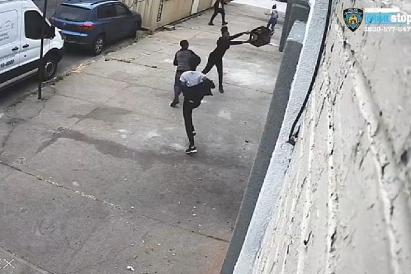 Screenshot of New York Police Department security footage showing a milk crate being thrown at the windows of a synagogue in the Williamsburg neighborhood of Brooklyn, N.Y. Source: Screenshot.