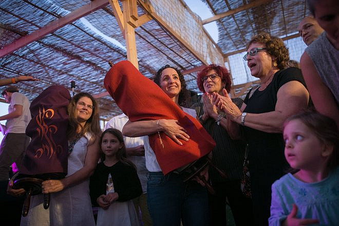 Simchat Torah celebrations inside a “sukkah” at the Tel Aviv port, organized by the Beit Tefila Israeli community. Photo by Miriam Alster/Flash90.