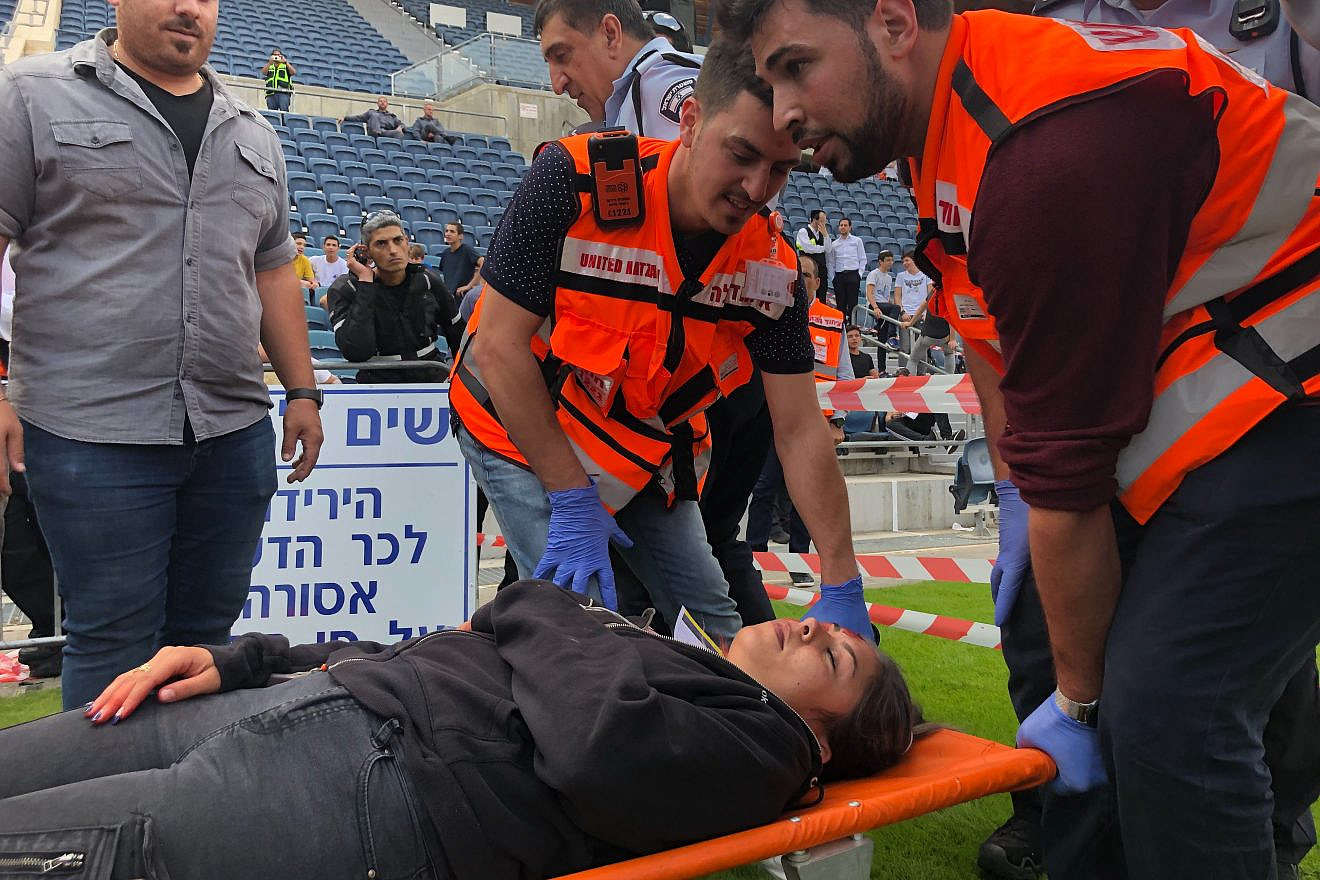 United Hatzalah emergency personnel treating a patient at a mass-casualty simulation at Teddy Stadium in Jerusalem. Photo by Eliana Rudee.