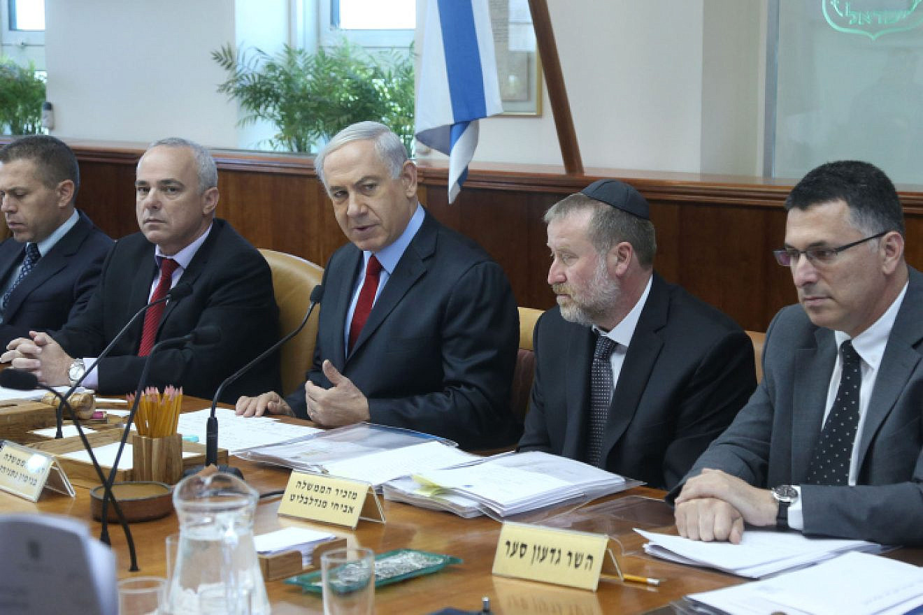 Israeli Prime Minister Benjamin Netanyahu leads the weekly Cabinet meeting, at his office in Jerusalem on June 8, 2014. To his right is then-Cabinet Secretary and current Attorney General Avichai Mandelblit; to his left is former Likud challenger and current New Hope Party leader Gideon Sa'ar. Photo by Marc Israel Sellem/POOL/Flash90.