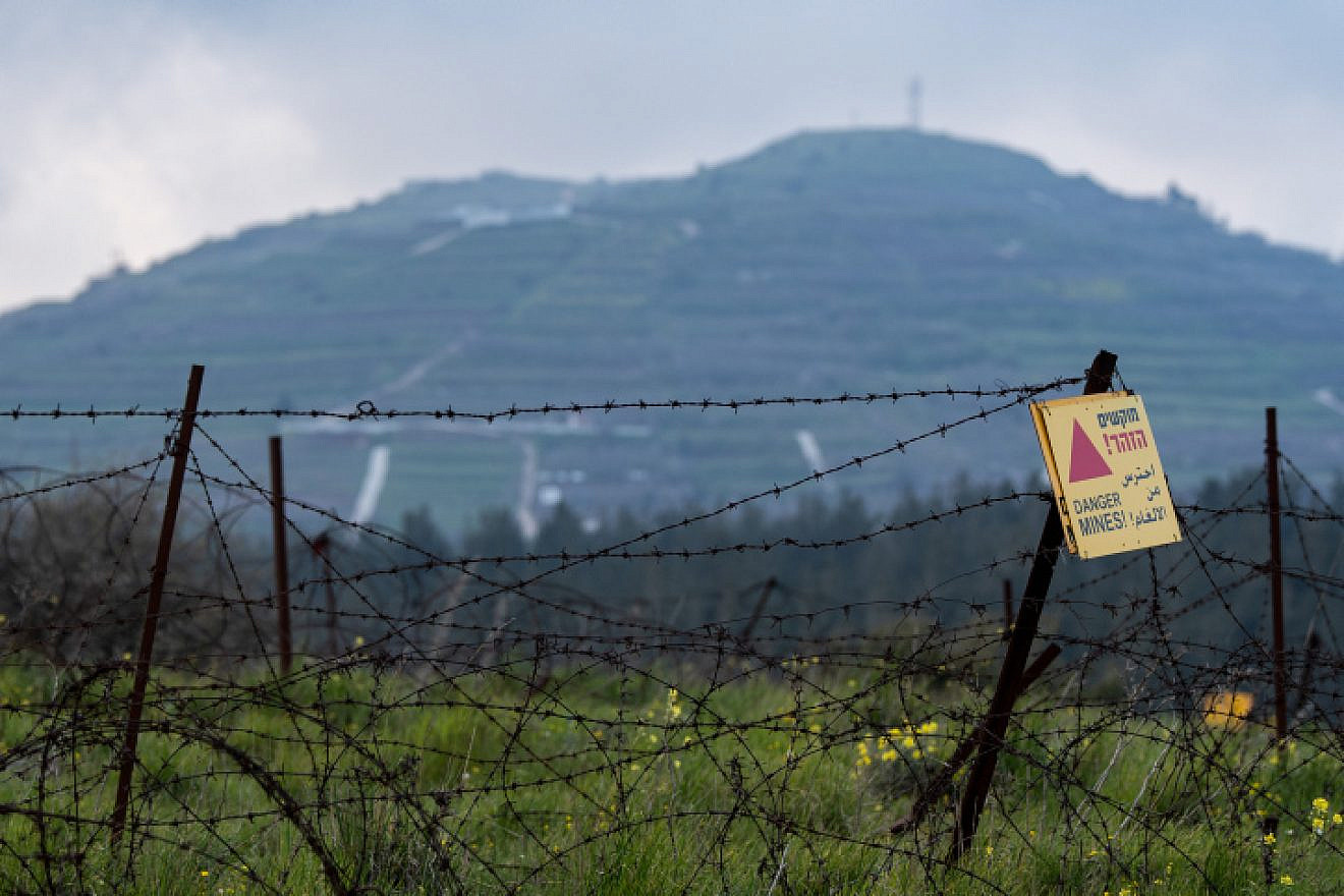 A sign warns of a minefield near the Syrian-Israeli border in the Golan Heights, March 25, 2019. Photo by Basel Awidat/Flash90.