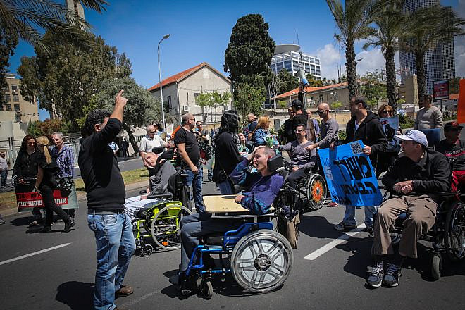 Disabled veteran Israel Defense Forces soldiers and their assistants protest outside the Defense Ministry in Tel Aviv, on March 29, 2016. Photo by Yossi Zamir/Flash90.