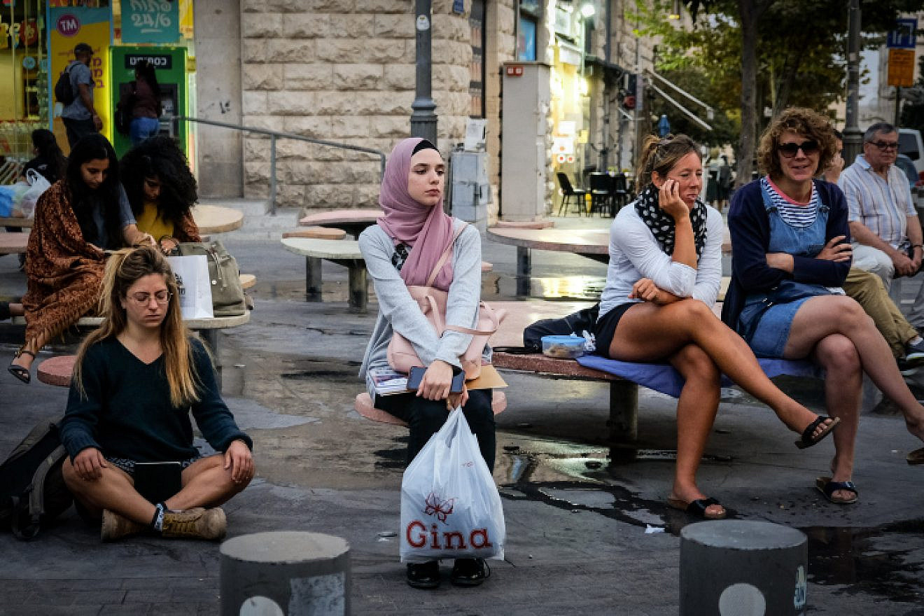 A young Arab woman sits on Jaffa Street in Jerusalem on Nov. 11, 2019. Photo by Sara Klatt/Flash90.