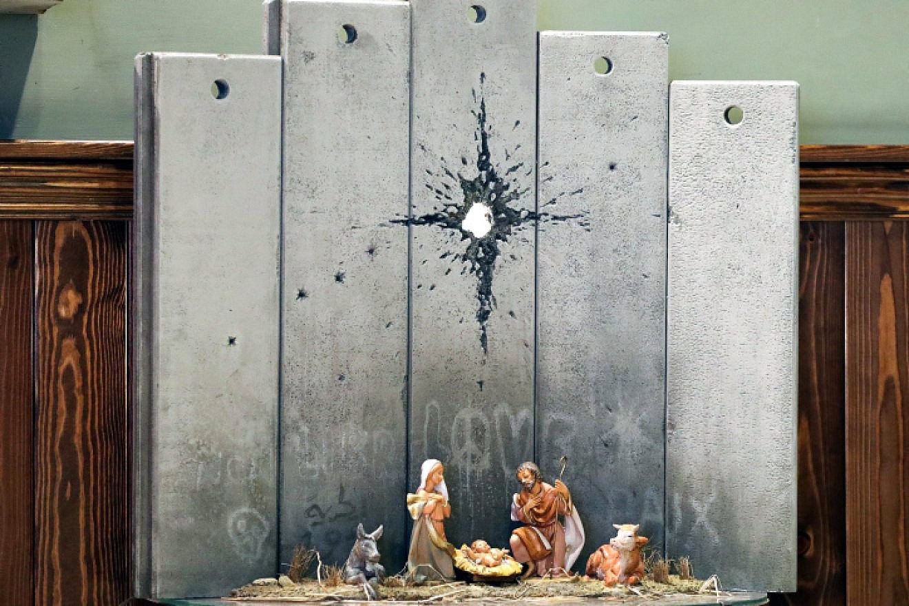 A view of a new artwork by British artist Banksy is displayed at the Walled Off hotel in the West Bank city of Bethlehem, on Dec. 22, 2019. Photo by Wisam Hashlamoun/Flash90.