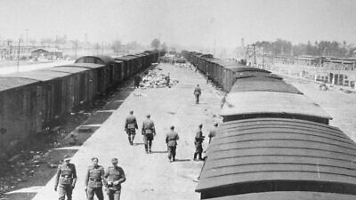 Nazi SS guards on the arrival ramp at the Auschwitz-Birkenau concentration and death camp in Poland, May 1944. Credit: United States Holocaust Memorial Museum/Courtesy of Yad Vashem, Jerusalem.