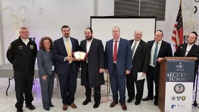 Jared Maples (third from left), the director of the N.J. Office of Homeland Security and Preparedness, accepts an award from a Jewish community leader from Jersey City. Maples spoke at a program on public safety by security officials and law-enforcement experts, Feb. 18, 2020. Credit: Orthodox Jewish Chamber of Commerce.