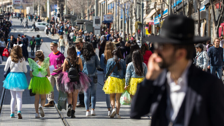 Costumed Israeli teenagers walk in the Jerusalem city center ahead of the Jewish holiday of Purim, on March 8, 2020. Photo by Olivier Fitoussi/Flash90.