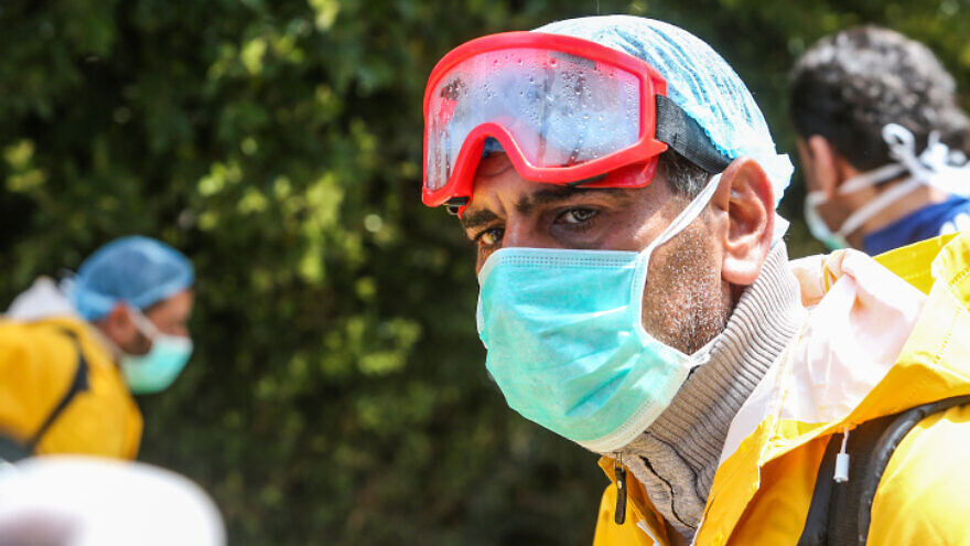 Palestinian health workers spray disinfectant on the streets as a precaution against coronavirus in Rafah, in the southern Gaza Strip, on March 22, 2020. Photo by Abed Rahim Khatib/ Flash90.