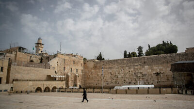 A Jewish man walks at the almost empty Western Wall, in the Old City of Jerusalem, March 27, 2020. Photo by Yonatan Sindel/Flash90.