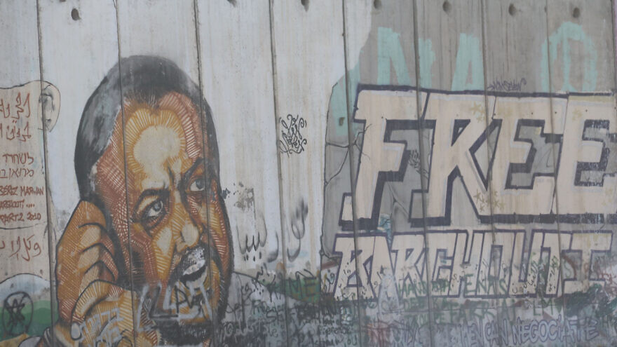 An image of Marwan Barghouti, the Fatah figure currently serving several life terms in an Israeli prison for murdering civilians, painted on the separation barrier near the West Bank village of Qalandiya, May 6, 2016. Photo by Haytham Shtayeh/Flash90.