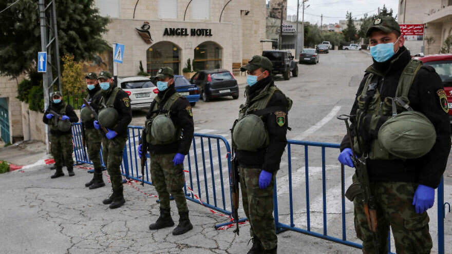 Palestinian security forces block the entrance to the Angel Hotel in the West Bank city of Bethlehem, March 19, 2020. Photo by Wisam Hashlamoun/Flash90.