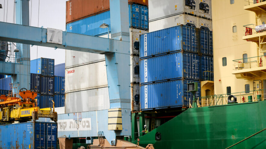 Workers unload shipping containers at Ashdod Port on Israel's southern coast on April 5, 2020. Photo by Flash90.