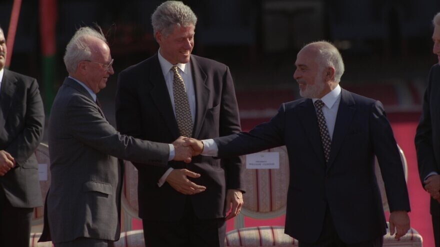 Israeli Prime Minister Yitzhak Rabin (left) and King Hussein of Jordan shake hands as U.S. President Bill Clinton looks on, after the signing of the Israel-Jordan peace treaty, on Oct. 26, 1994. Photo: Avi Ohayon/GPO.