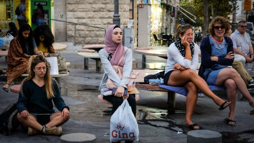 A young Arab woman sits on Jaffa Street in Jerusalem on Nov. 11, 2019. Photo by Sara Klatt/Flash90.