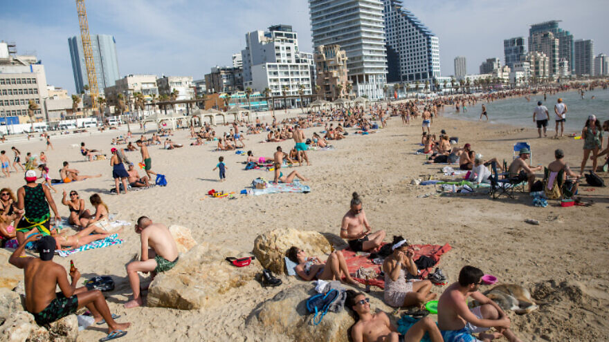 Israelis enjoy the beach in Tel Aviv as temperatures rise to 40 degrees Celsius (more than 100 degrees Fahrenheit) in some parts of the country on May 16, 2020. Photo by Miriam Alster/Flash90.