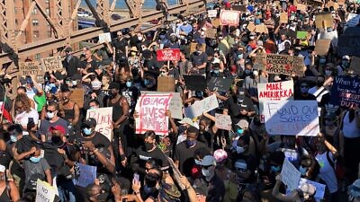 A Black Lives Matter mass protest on the Brooklyn Bridge in New York City while certain lockdowns still exist due to the coronavirus pandemic, June 9, 2020. Credit: Stan Wiechers via Wikimedia Commons.