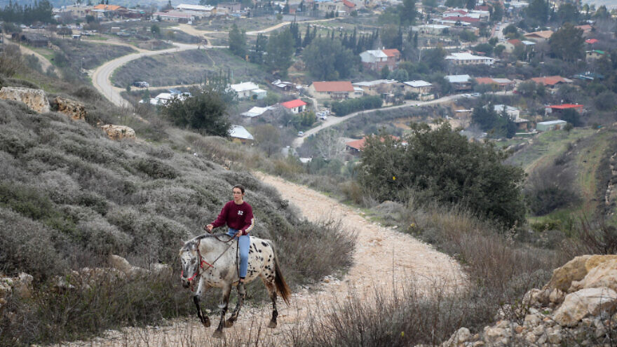 A woman on horseback in Bat Ayin, in Gush Etzion, on Feb. 2, 2020. Photo by Gershon Elinson/Flash90.
