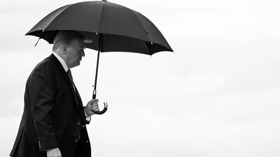 Then-U.S. President Donald Trump carries an umbrella as he walks from Marine One to board Air Force One at Joint Base Andrews, Md., on June 20, 2020, en route to Tulsa, Okla. Credit: Tia Dufour/The White House.