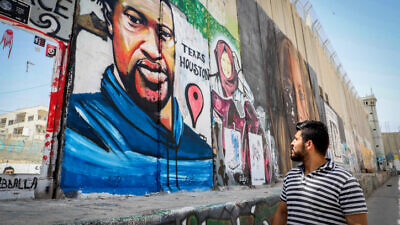 Palestinians walk past a mural of George Floyd painted on a section of the security barrier in the city of Bethlehem, June 8, 2020. Photo by Wisam Hashlamoun/Flash90.