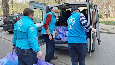 Staff and volunteers with the American Jewish Joint Distribution Committee (JDC) distribute food packages to the Jewish community in Kishinev, Moldova, 2020. Credit: Courtesy.