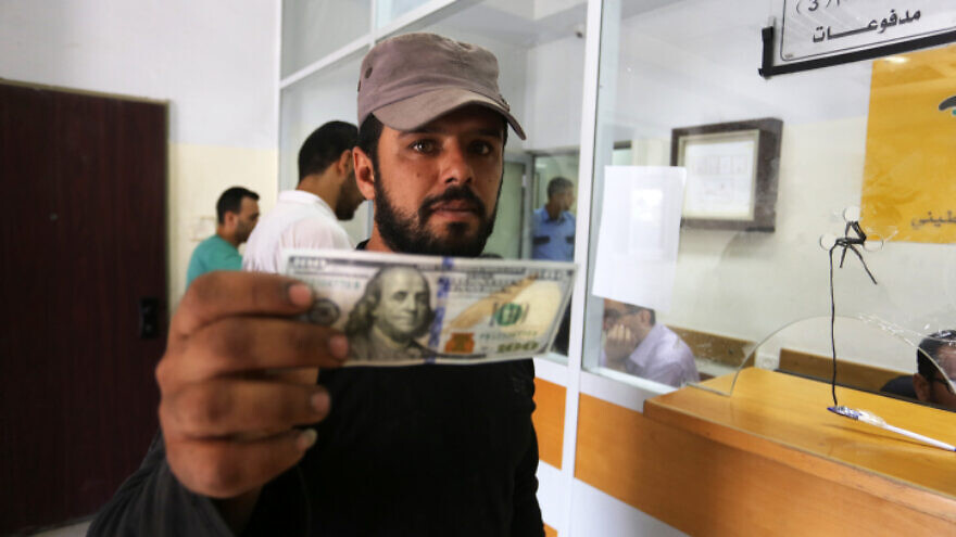 Palestinians receive Qatari financial aid at a post office in Rafah in the southern Gaza Strip, June 27, 2019. Photo by Abed Rahim Khatib/Flash90.