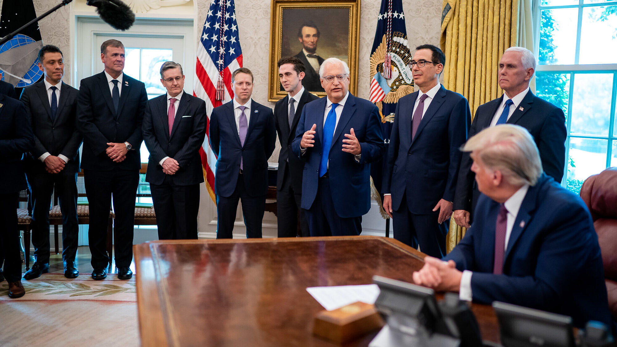 U.S. President Donald Trump listens as U.S. Ambassador to Israel David Friedman delivers remarks during the announcement of normalization of relations between Israel and Bahrain on Sept. 11, 2020, in the Oval Office of the White House. Credit: Tia Dufour/The White House.