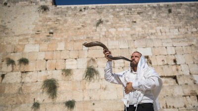 A Jewish man blows a shofar at the Western Wall in Jerusalem's Old City, on Aug. 16, 2018. Photo by Yonatan Sindel/Flash90.