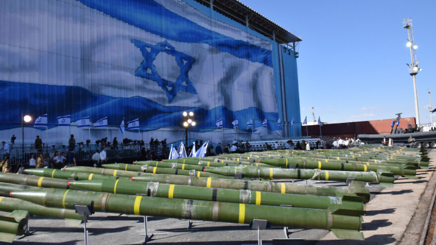 Israeli Navy soldiers examine dozens of mortar shells and rockets on display, at a military port in Eilat, after being seized from the Panama-flagged KLOS C civilian cargo ship which Israel raided in the Red Sea, and which according to the Israeli military was carrying dozens of advanced rockets from Iran destined for Palestinian militants in Gaza. March 10, 2014. Photo by Yehuda Ben Itach/Flash90.