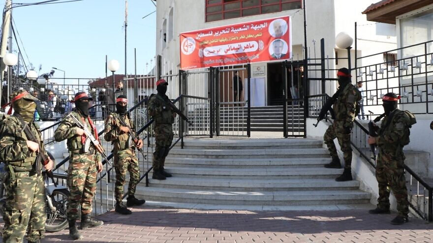 Fighters of the PFLP’s Abu Ali Mustapha Brigades standing at the entrance of Red Crescent Society for the Gaza Strip's building. Credit: Red Crescent Society for the Gaza Strip.