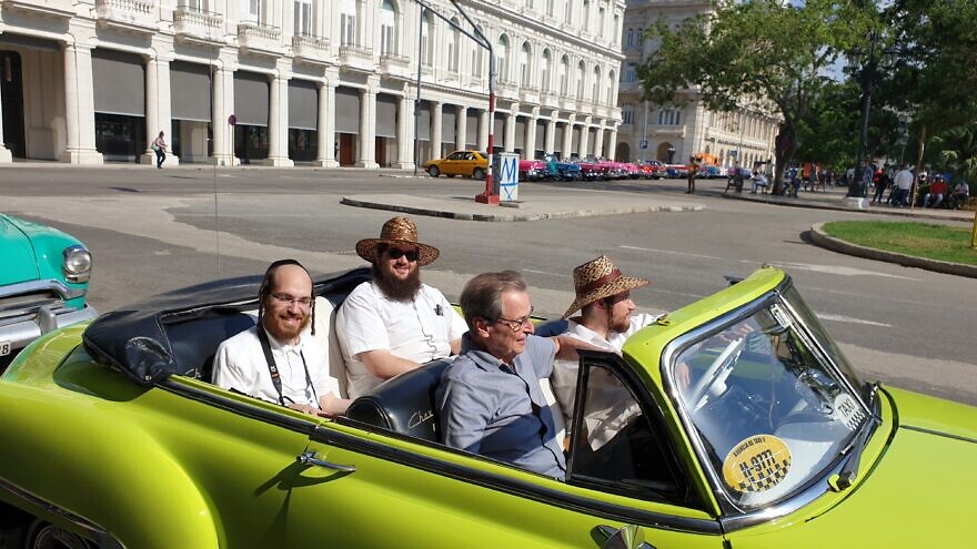 Saul Berenthal (front left), 75, was born and raised in Cuba but left for Miami in 1960, following the 1959 Castro revolution. He is pictured here in Havana, cruising around in a classic 1950s American-made car. Credit: Courtesy.