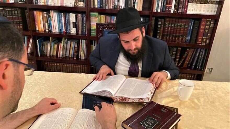 Rabbi Levi Duchman studies with a member of the UAE Jewish community at his synagogue. Credit: Chabad.org/News.