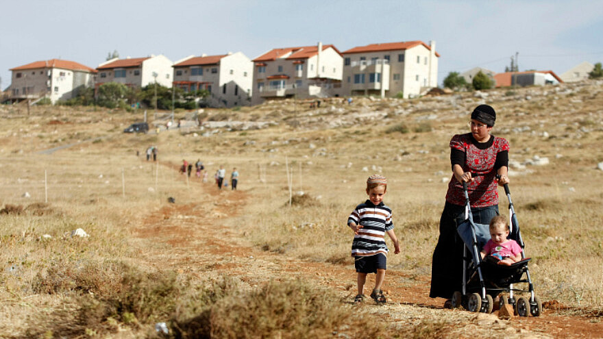 A woman and her children walk towards Kochav Hashachar in Judea and Samaria on June 4, 2009. Photo by Abir Sultan/Flash90.
