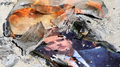 A picture of French President Emmanuel Macron burned by Palestinians during a protest against both the publication of a cartoon depicting the Islamic prophet Muhammad in France and Macron's resulting comments on Oct. 2, near the West Bank town of Hebron, on Oct. 27, 2020. Photo by Wisam Hashlamoun/Flash90.
