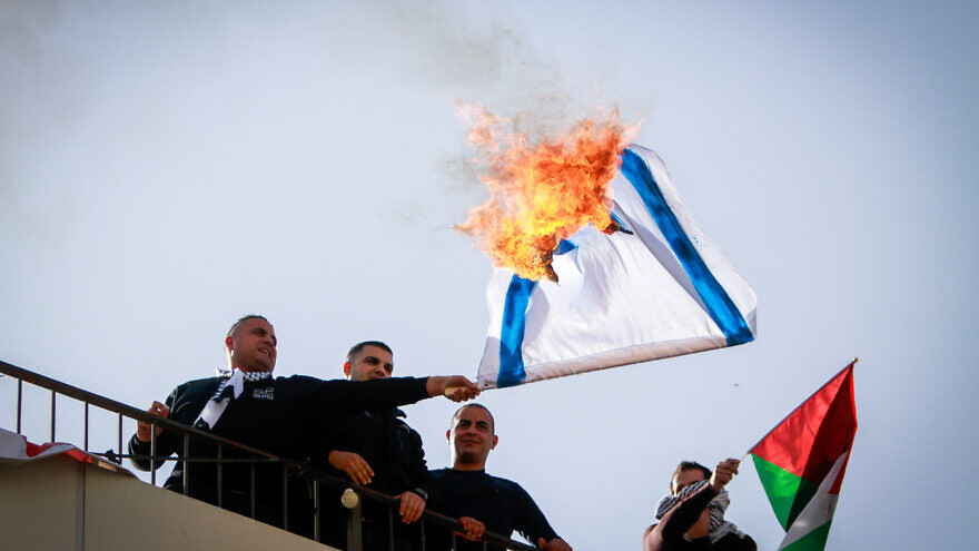 Palestinian demonstrators in Nablus burn an Israeli flag during a protest against the U.S. position on Israeli settlements, Nov. 26, 2019. Photo by Nasser Ishtayeh/Flash90.