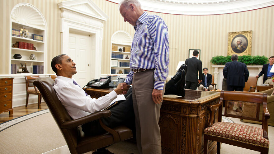 U.S. President Barack Obama and Vice President Joe Biden shake hands in the Oval Office following a phone call with House Speaker John Boehner securing a bipartisan deal to reduce the nation's deficit and avoid default, July 31, 2011. Credit: Official White House Photo by Pete Souza.