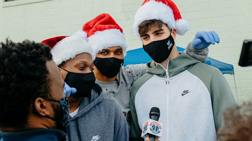 Israeli basketball player Deni Avdija being interviewed as he and team members deliver Christmas presents to the local community, December 2020. Credit: Courtesy of the Washington Wizards.