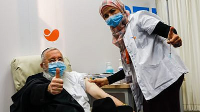 An Israeli receives a COVID-19 vaccine in Jerusalem on Dec. 21, 2020. Photo by Olivier Fitoussi/Flash90.