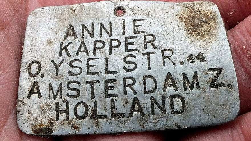 This ID tag was worn by Annie Kapper, a Jewish child from Amsterdam who was deported to the Sobibor extermination camp. Credit: Yoram Haimi/Israel Antiquities Authority.