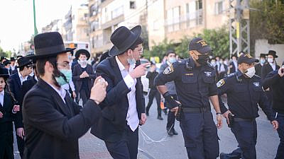 Israel Police officers clash with haredim during a protest against the enforcement of coronvirus lockdown restrictions in Bnei Brak on Jan. 24, 2021. Photo by Tomer Neuberg/Flash90.