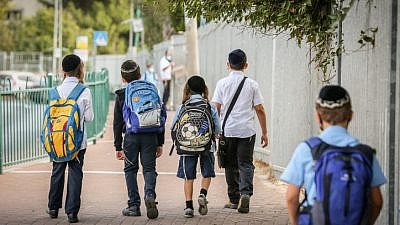 Israeli children wearing face masks make their way to school in Tzfat on their first day back to classes on Nov. 1, 2020. Photo by David Cohen/Flash90.