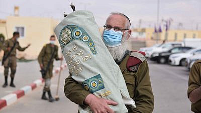 Brig. Gen. Eyal Karim, chief rabbi of the Israel Defense Forces, holds a new Torah scroll for use by the Tomer division of the Givati Brigade, Feb. 17, 2021. Credit: IDF.