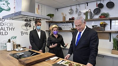 Israeli Prime Minister Benjamin Netanyahu samples meat produced by Aleph Farms on Dec. 7, 2020. Credit: GPO/Koby Gidon.