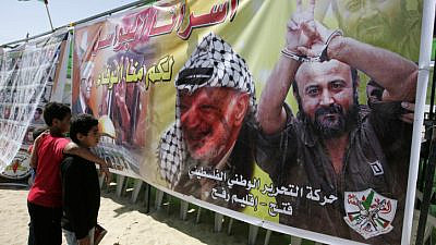 Palestinian children look at the image of PLO chief Yasser Arafat and terrorist Marwan Barghouti during a demonstration in the southern Gaza Strip calling for the release of prisoners held in Israeli jails on Oct. 6, 2011. Photo by Abed Rahim Khatib/Flash90.