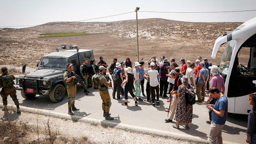 Israeli soldiers detain Israeli left-wing activists during a tour led by NGO Breaking the Silence in Mitzpe Yair, near Hebron, on Aug. 31, 2018. Photo by Wisam Hashlamoun/Flash90.