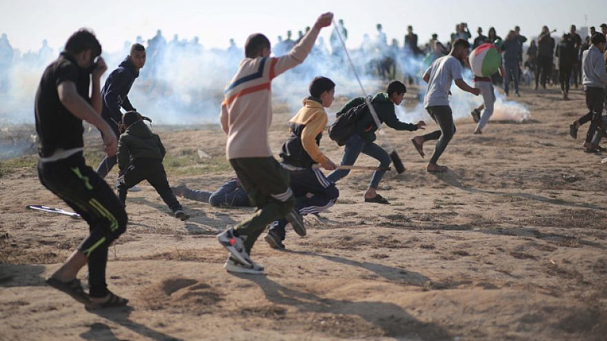 Palestinians take part in riots on the Gaza border, slinging stones at Israeli security forces, March 2021 Photo by Hassan Jedi/Flash90.