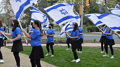 Students from the Joseph Kushner Hebrew Academy perform an Israeli flag routine at a Yom Ha’azmaut event in Livingston, N.J., on April 15, 2021. Photo by Faygie Holt.