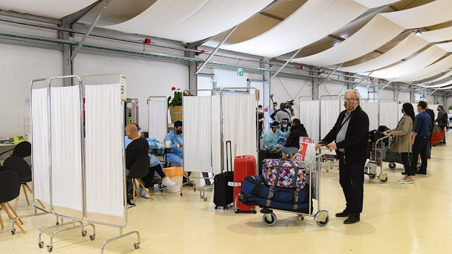 Medical technicians test passengers for COVID-19 at Ben-Gurion International Airport, March 8, 2021. Photo by Flash90.