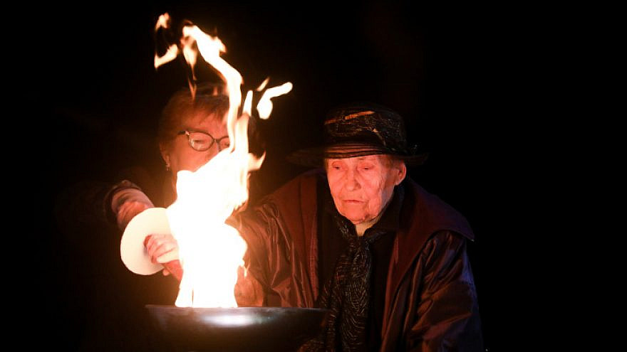 A Holocaust survivor lights a torch during a ceremony at the Yad Vashem Holocaust Memorial Museum in Jerusalem, as Israel marks Holocaust Remembrance Day, April 7, 2021. Photo by Olivier Fitoussi/Flash90.