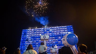 Israelis watch fireworks during a show to mark Israel's 73rd Independence Day, in Rabin Square in Tel Aviv on April 14, 2021. Photo by Miriam Alster/Flash90.