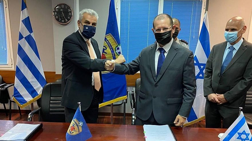 IDF Brig. Gen. (res.) Yair Kulas (right) and Theodoros Lagios, director-general of the Greek General Directorate for Defense, at the signing of the largest-ever defense procurement agreement between Israel and Greece, April 18, 2021. Credit: Hellenic Ministry of Defense.